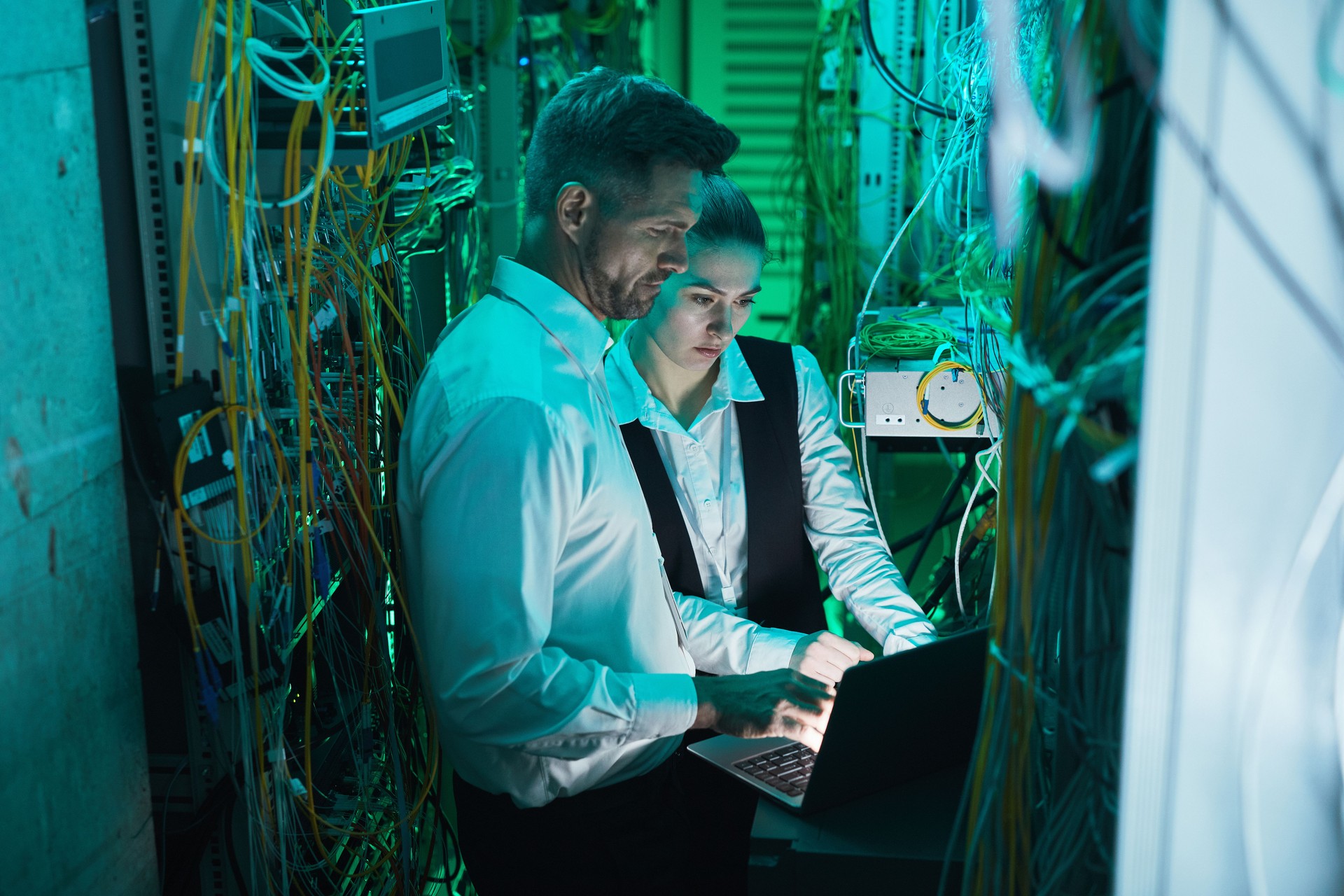 In-house IT staff collaborating with an MSP technician on shared network systems.